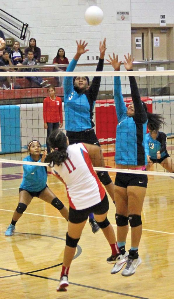 Navajo Prep’s Jasmine Coleman (left) and Gabrielle Noon (right) team up for block on Sept. 2 in Shiprock. The Lady Eagles defeated Shiprock, 3-1. (Times photo - Sunnie R. Clahchischiligi)