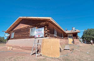 Anthony Lee, a member of the Navajo Hopi Honor Riders, volunteers his time and works to complete the roof of Navajo Code Talker Kee Etsicitty’s home on Sunday in Chichiltah, N.M. (Times photo - Donovan Quintero)