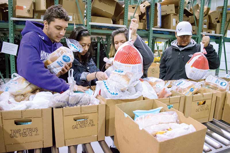Gallup Rotary Club hands out 100 food baskets