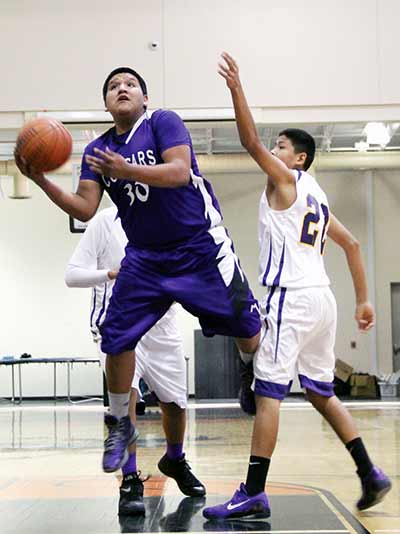 Monument Valley’s (Utah) Kurtis Holliday (30) goes up for a layup against Kirtland Central’s junior varsity team in the Navajo Prep Classic Boys Basketball Tournament held Dec. 4-6. Monument Valley defeated Kirtland Central, 68-62. (Times photo – Sunnie R. Clahchischiligi)