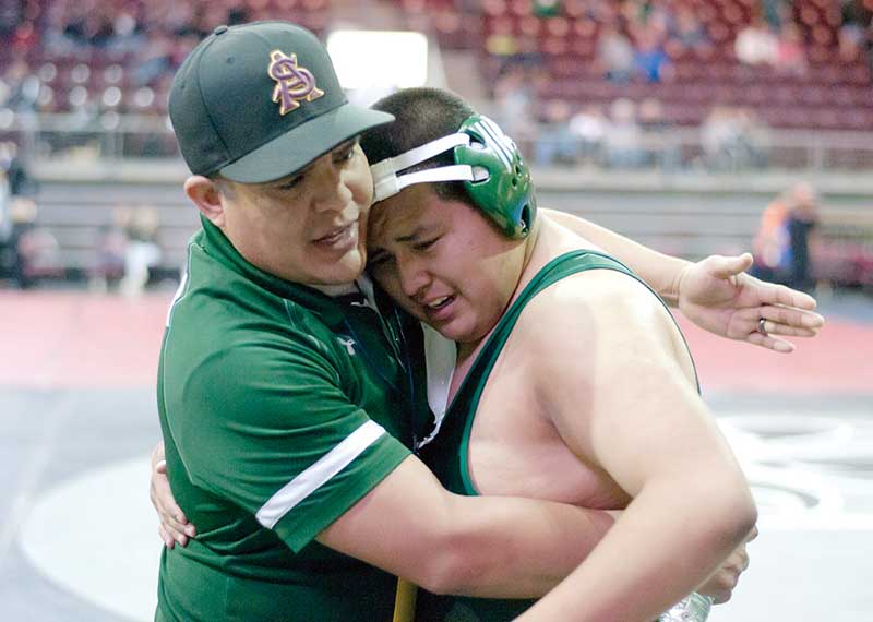 Tuba City Warrior Adrian Sixkiller, right, is congratulated by his coach Brandon Williams after he won the third place match in the 220-pound weight class in Prescott Valley, Ariz. on Friday. (Times photo - Donovan Quintero)