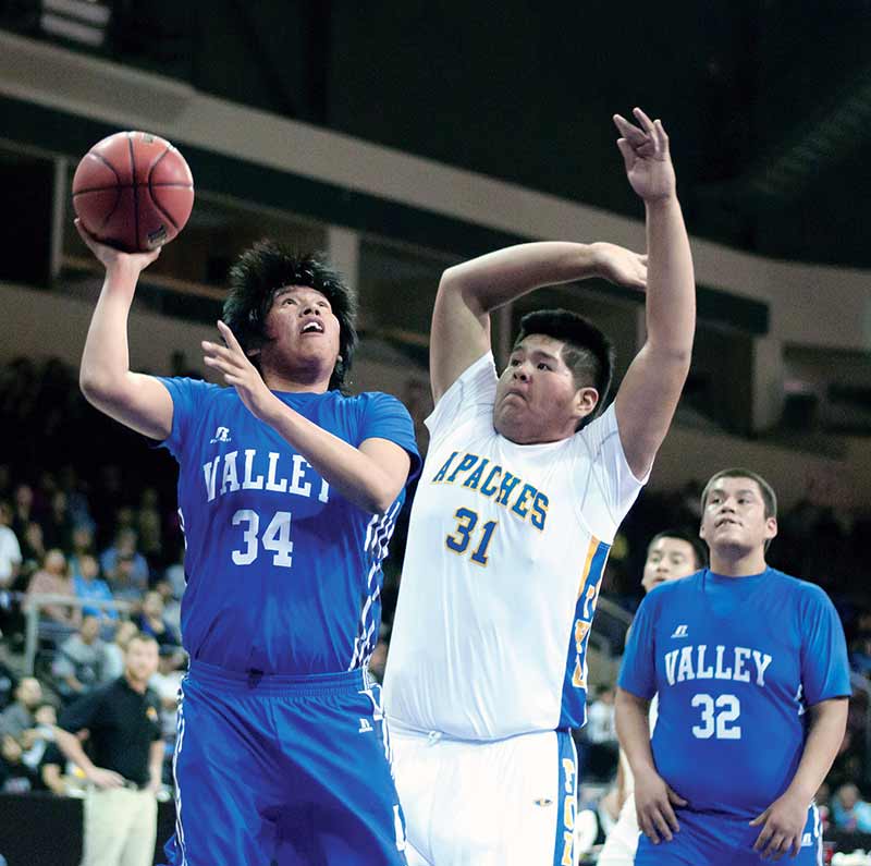 Valley Pirate Jowasen Yazzie (34) shoots the ball while being guarded by Fort Thomas Dechambre Dosela (31) on Saturday. (Times photo – Donovan Quintero)