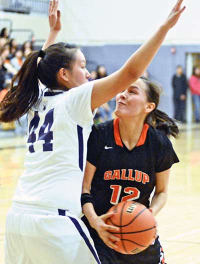 Gallup’s Kristin Quigley (12) looks to score while be heavily guarded by Miyamura’s Alaiah Nelson (44) during second half of prep girls action at Miyamura High School on Tuesday, Feb. 3. The Lady Bengals defeated the Lady Patriots, 66-21. (Times photo – Paul Natonabah)