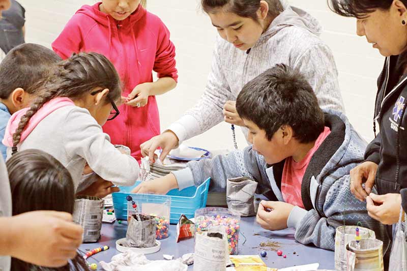 Students pick out beads to decorate their newspaper pots during the Green Hornet’s Garden Club event last Thursday in Ganado. (Times photo - Stacy Thacker)