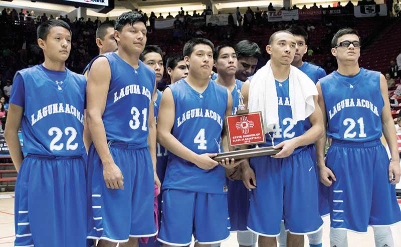 The Laguna-Acoma Hawks pose with their Class 3A runner-up trophy on Saturday in Albuquerque after losing to the Mesilla Valley Sonblazers, 63-49, at the WisePies Arena. (Times photo - Donovan Quintero)