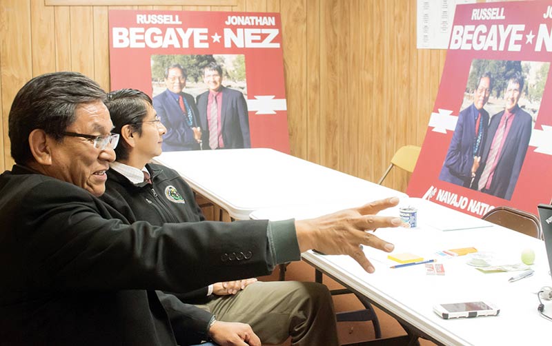 Navajo presidential candidate Russell Begaye points at the board as his running mate Jonathan Nez inspects their campaign poster on Tuesday at their campaign headquarters in Window Rock. (Times photo - Donovan Quintero)