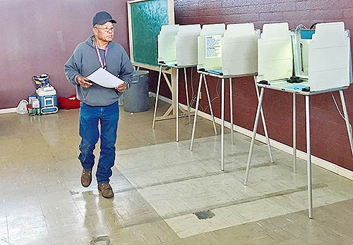 A voter on Tuesday evening walks toward the ballot box after casting his vote at Ts’ah Bii Kin, Ariz. According to unofficial results, Begaye-Nez received 185 votes here while Shirley-Benally received 53. (Times photo – Krista Allen)
