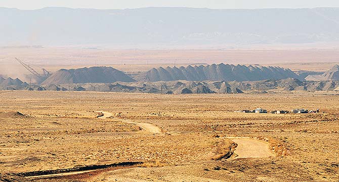 A homestead sets out in the open range as a Navajo Mine dragline excavator digs for coal, leaving large piles of dirt along its path in November 2013 in Burnham, N.M. (Times file photo.)