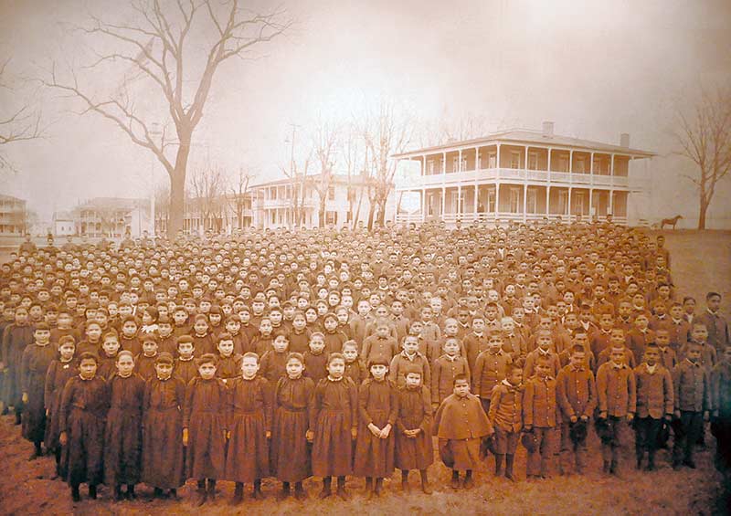 An 1882 photograph taken by John N. Choate depicts Native American students posing in front of the Carlisle Indian School in Carlisle, Penn. The students in this photograph represent different Native tribes from all over the United States. (Special to the Times – Ravonelle Yazzie)