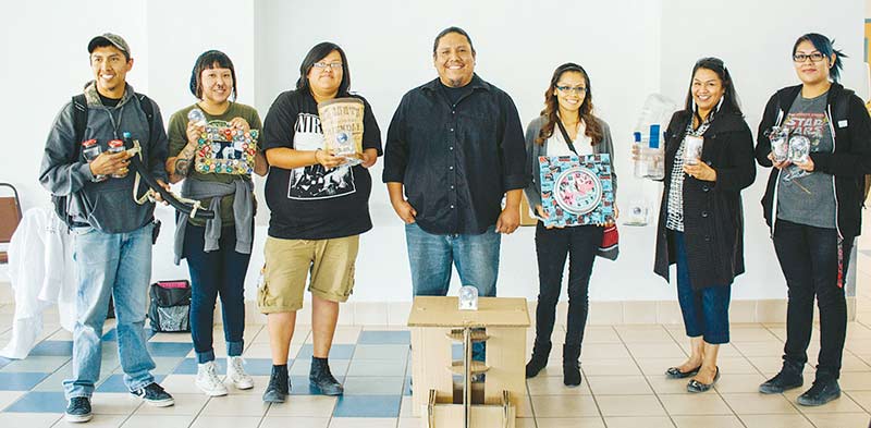 Students who participated in Navajo Technical University’s Recycling Contest stand together with their creations. The contest was designed to get students thinking about recycling. (Courtesy photo)
