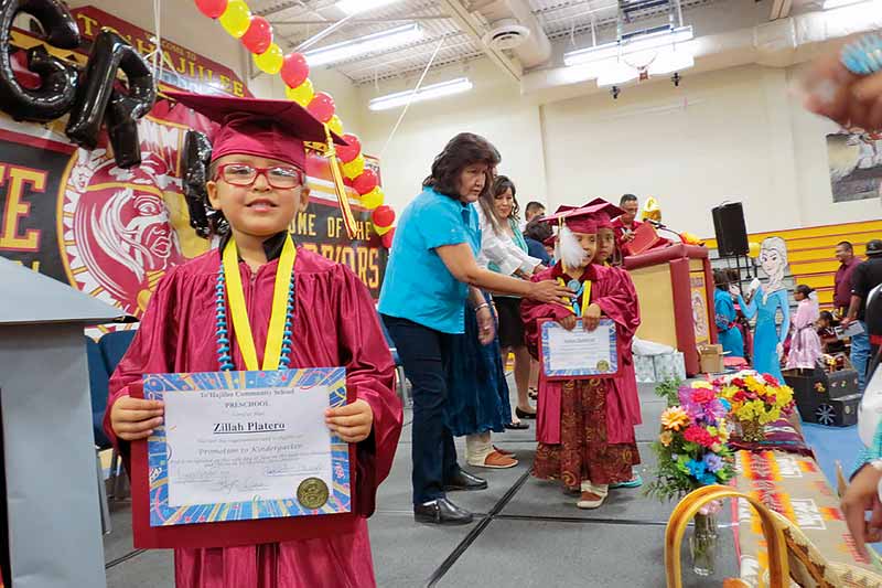 Pre-school graduate Zillah Platero holds up her certificate of promotion during the To’Hajiilee Community School’s ceremony on June 12. (Special to the Times - Colleen Keane) 