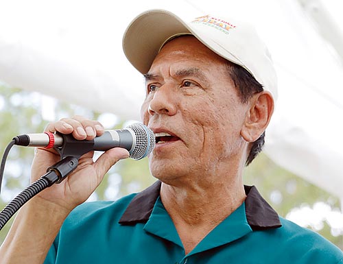 Actor Wes Studi talks to the crowd before the start of the grand opening of the Saddle Up! exhibit at the Toadlena Trading Post on Saturday. The event included live music, food and was a celebration of the new exhibit for the community. (Times photo - Stacy Thacker)