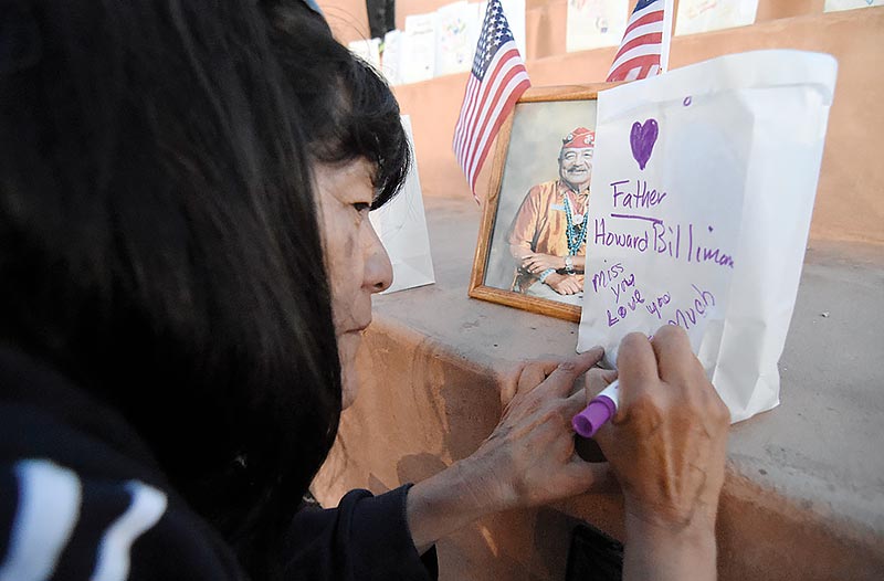 Maggie Billiman writes a short memento that expresses her thoughts and emotions for her late father Navajo Code Talker Howard Billiman at the 15th annual Relay For Life in Gallup. (Times photo – Donovan Quintero)