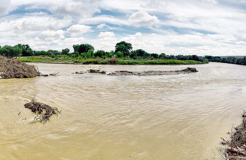 Ripples form as the San Juan River flows down by the Upper Fruitland, N.M., area last Saturday. (Times photo - Donovan Quintero)