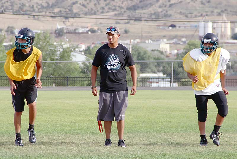 Navajo Preparatory School new head coach Storm Tallbull (center) monitors his players during a preseason practice this month. Tallbull moved from an assistant coach to head coach at Navajo Prep. (Times photo – Sunnie R. Clahchischiligi)