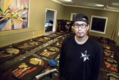 Randy L. Barton stands in front of several of his original paintings. He was commissioned to create this painting, for the Eldorado Hotel & Spa, in addition to over 70 other pieces. (Courtesy photo)