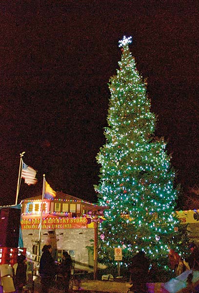 The Western Navajo Christmas Tree is lit Nov. 20 after a lighting countdown lead by three Diné female military veterans. The tree, a corkbark fir, is 58 feet tall and is from the Chuska Mountains.