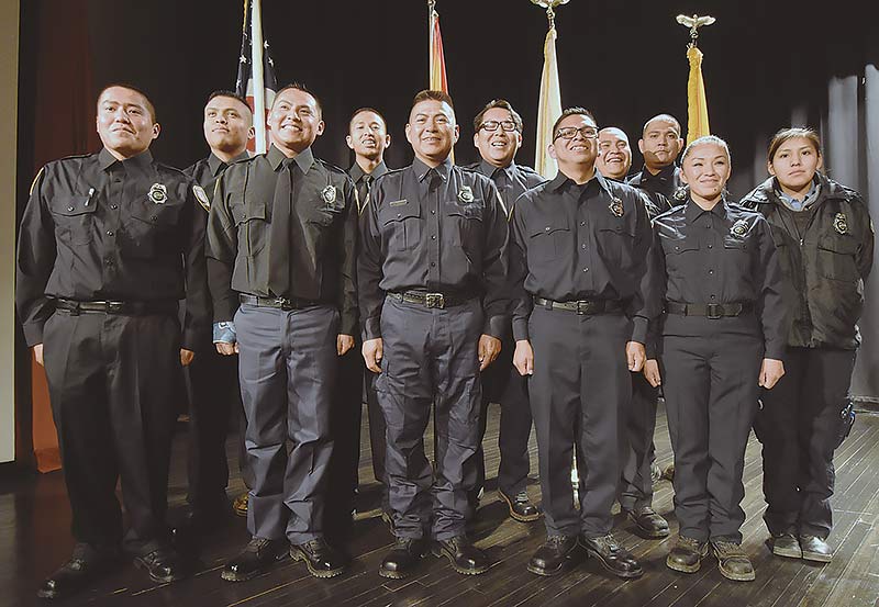 Navajo Times | Donovan Quintero Newly sworn-in Navajo Nation firefighters (from left to right) are Delwin Dooline, Emillio Warner, Spencer White, Kody Ayze, Randy Frank, Jordon Ellis, Gerald Todacheenie, Terrance Nasafotie, Lt. Michael Begay, Marla Kinlecheenie, and Donnikka Little, pose for their families during their graduation ceremony Wednesday.