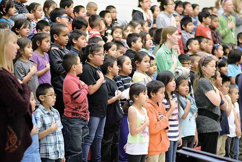 Navajo Times | Donovan Quintero Students at the new Catherine H. Miller Elementary School say the Pledge of Allegiance Tuesday morning during a grand opening ceremony in Church Rock, N.M.