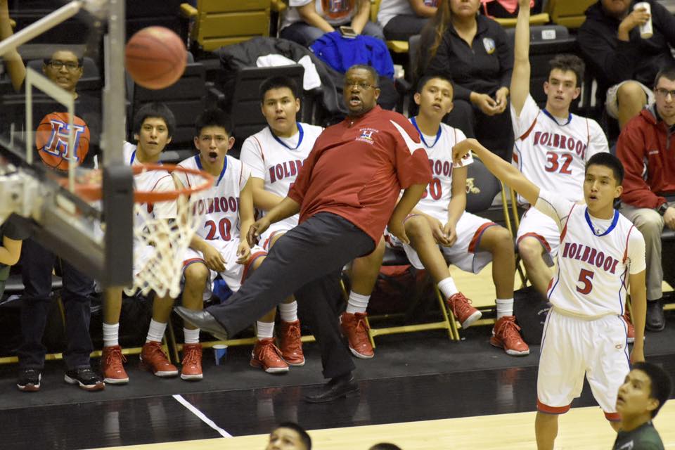Holbrook head coach Delmar Johnson reacts to a three-point attempt by Roadrunner Rhett Desiderio (5) Wednesday against the Tuba City Warriors in Chinle. Desiderio eventually made the shot.