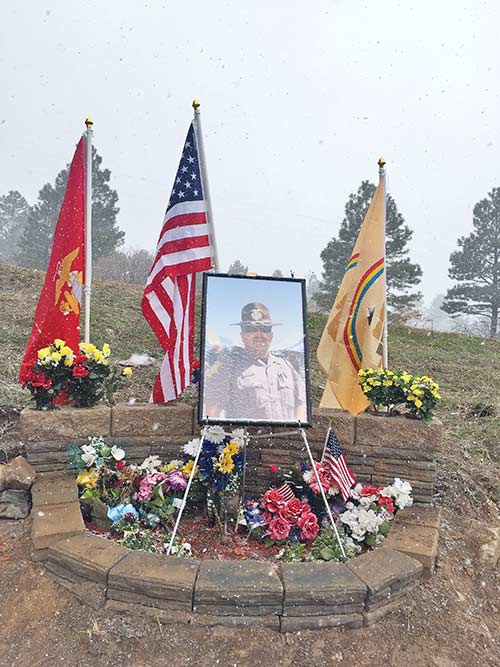 Navajo Times | Donovan Quintero A photograph of fallen Navajo police officer Alex Yazzie stands in the middle of a memorial site along Navajo Route 5 in Red Valley, Ariz.
