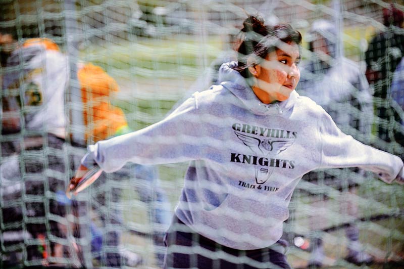 Headwind provides lift for Greyhills discus throwers