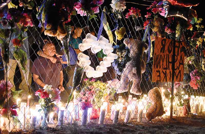 Navajo Times | Donovan Quintero Mourners console each other while lighting a candle for Ashlynne Mike, 11, along Navajo Route 36. Mike, a fifth grade student at Ojo Amarillo Elementary and her brother Ian Mike, 9, were abducted by a man in the Fruitland, N.M. area. Mike’s body was later found.