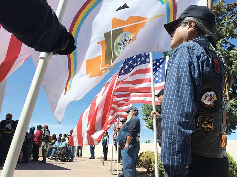 Navajo Times | Donovan Quintero Johnny Notah stands at attention and holds the Navajo Nation flag Wednesday at the Santa Fe National Cemetery.