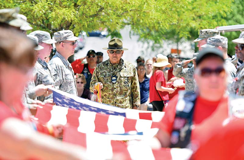 Navajo Times | Donovan Quintero PJ “Gunny” James from Gallup, stands at attention with the Navajo Code Talker flag during a refolding of the flag ceremony in Gallup on Memorial Day. 
