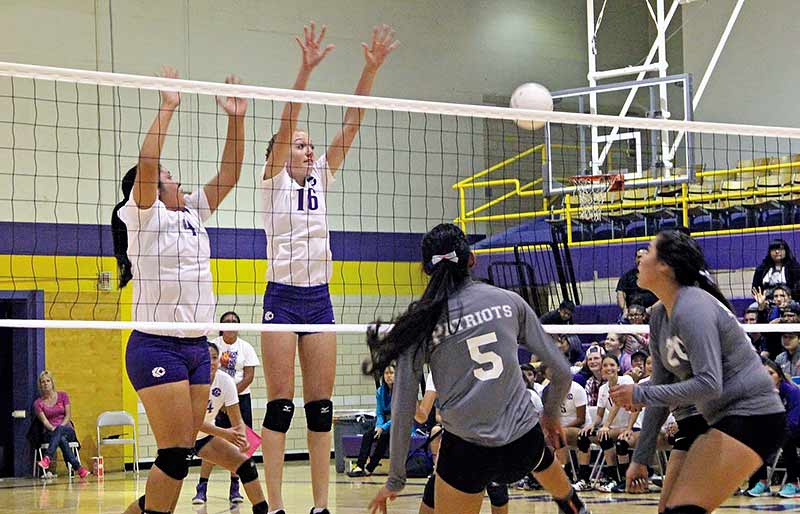 Sunnie R. Clahchischiligi | Navajo Times Two Kirtland Central High School players jump for a block during a 5A District 1 match with Miyamura on Tuesday. The Lady Broncos won, 3-1.