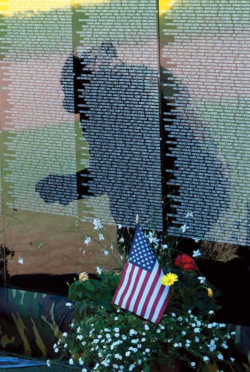 Navajo Times | Donovan Quintero A man is reflected in The Moving Wall, a half-size replica of the Vietnam Memorial that visited Chinle last weekend.