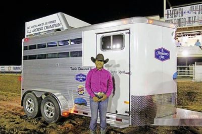 Standing by the trailer in rodeo grounds