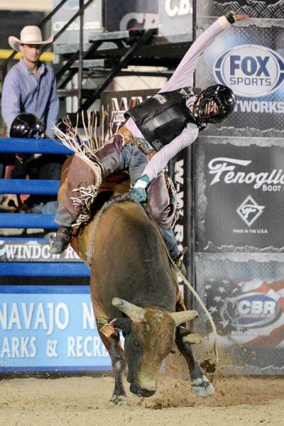 Bucking bull tries to toss rider off its back.