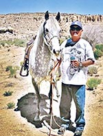 man standing with horse, and holding a water bottle