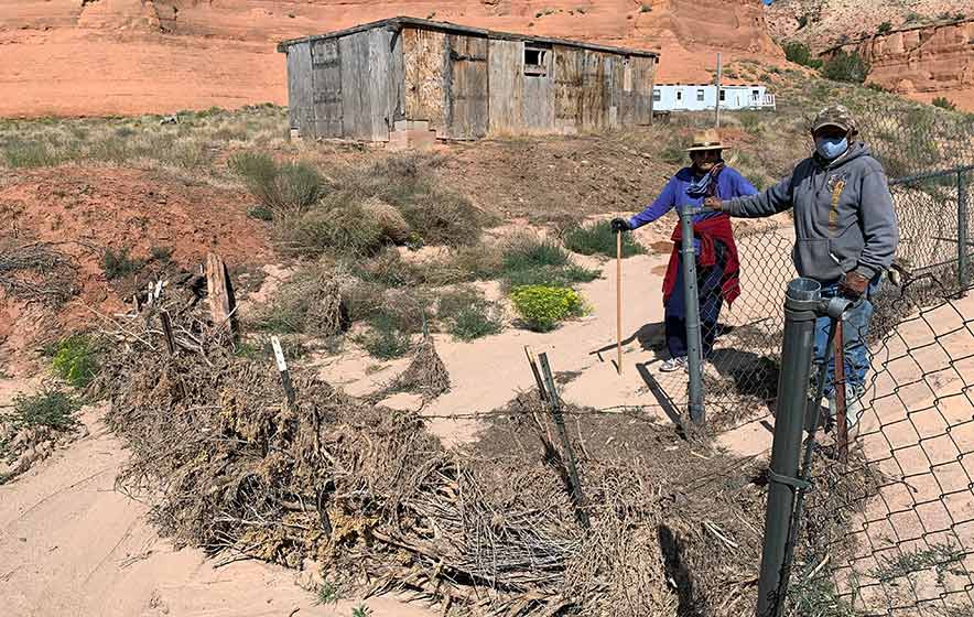 Brush dams save home from flood, pile up soil