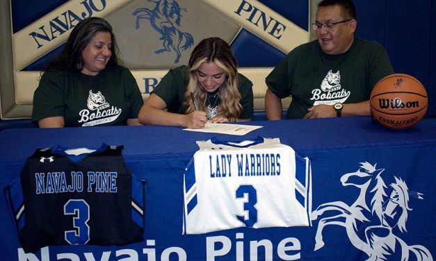 Navajo Pine standout signs with New York college