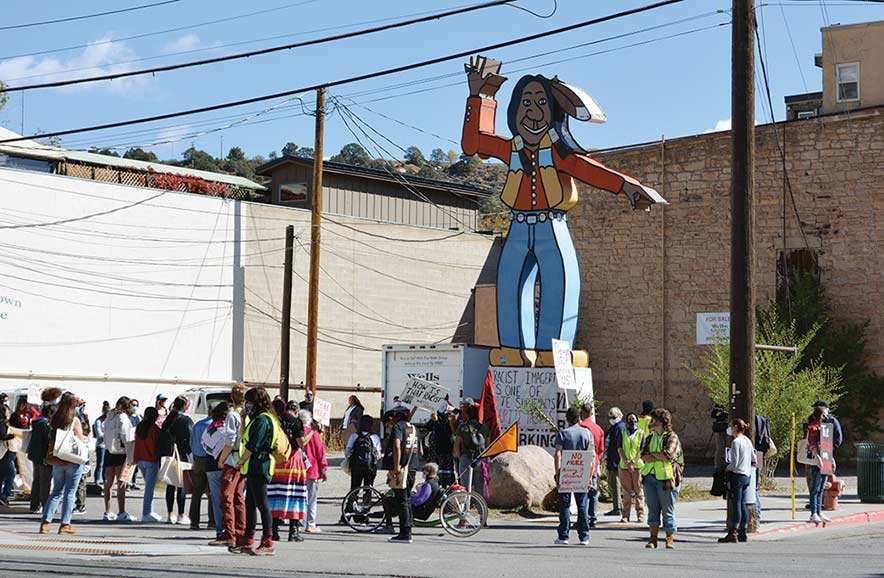 Marchers rally against ‘the chief’ sign