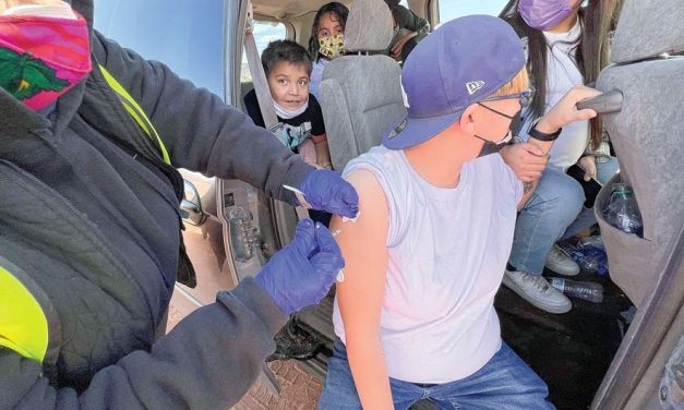 Redefining community health:  Diné get free boxes of N95 at mobile vaccine clinic