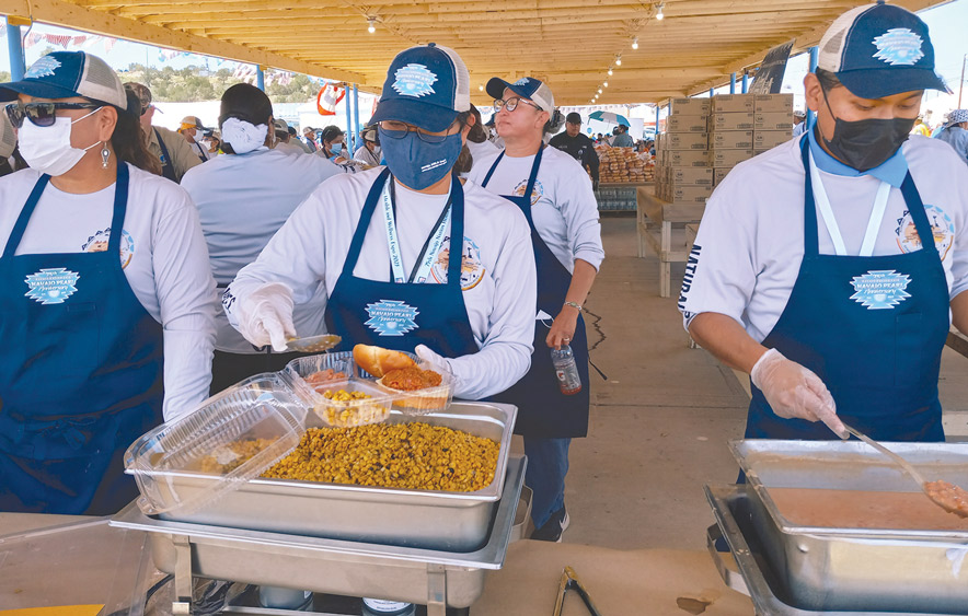 Division of Natural Resources staff serve pulled pork barbecue to hungry fairgoers