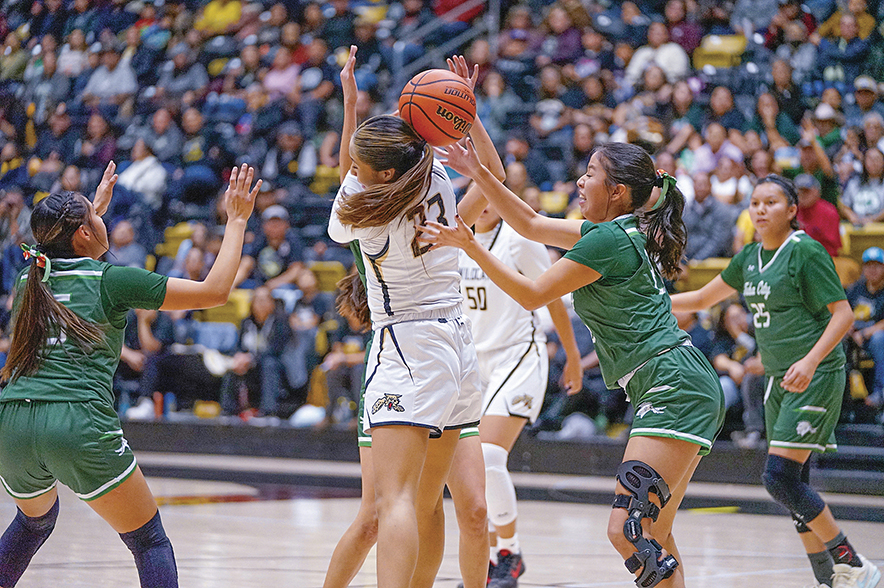 Navajo Times | Quentin JodieChinle Lady Wildcat Noelle Walker (11) drives the baseline against Tuba City’s Taimani Tso (right) during a 3A North Region game on Friday night. The Lady Wildcats sit atop the 3A and Copper Division rankings in the latest AIA polls.